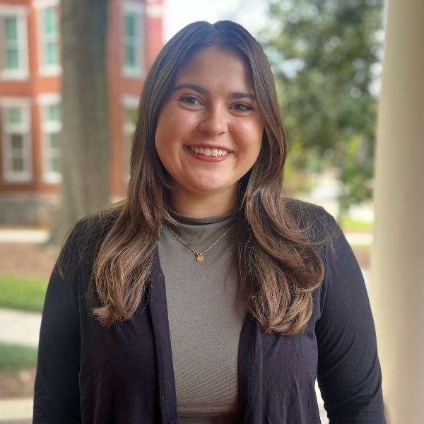 a headshot of Abby Smithwich on a porch of a building